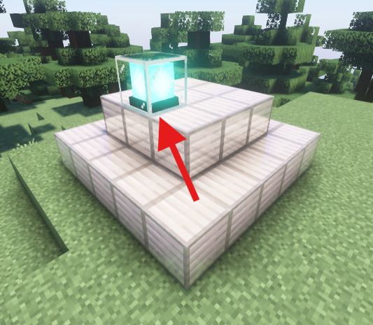 A Minecraft beacon placed on a pyramid of iron blocks, with a red arrow pointing to the side of the beacon's base layer.